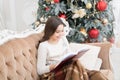 Love winter fairy tale. Our traditions. cosy evening at home. new year eve. best xmas book. small girl reader enjoy Royalty Free Stock Photo