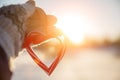 Love in winter. Heart shaped symbol Valentine Day. heart with hands, Feelings and Lifestyle concept on the sunset light Royalty Free Stock Photo