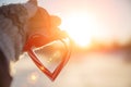 Love in winter. Heart shaped symbol Valentine Day. heart with hands, Feelings and Lifestyle concept on the sunset light