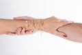 Love woman hands gripping man arm hanging on with jewelry bracelets Royalty Free Stock Photo