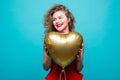Love woman smiling holding red heart shaped balloon. Cute beautiful young woman in love. Caucasian female model in red dress isola Royalty Free Stock Photo