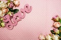 Love word alphabet and Gift box with roses bouquet with space copy on pink polka dot background Royalty Free Stock Photo