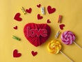 Love word, heart and lollipop candies on yellow paper background. Top view