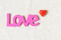 Love word and heart shaped cookie on linen background Royalty Free Stock Photo