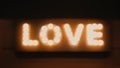 Love word made of glowing light bulbs