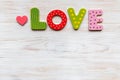 LOVE word made in wooden letters and wood heart on wooden vintage board. Valentines day concept Royalty Free Stock Photo