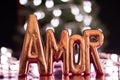 Love word in portuguese with Heart shaped neon lights background