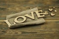 Love word, small hearts on dark wood background. Top view of Valentine`s Day Royalty Free Stock Photo