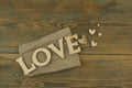 Love word, small hearts on dark wood background. Top view of Valentine`s Day Royalty Free Stock Photo