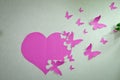 Love word with texture .valentine day background . Pink heart and butterflies made of paper on the wall Royalty Free Stock Photo
