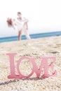 Love word on tropical background, beach wedding concept Royalty Free Stock Photo