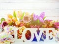 Love word wooden letter with artificial flowers decor