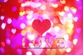 Love word wooden texture on blur bokeh background for valentine'