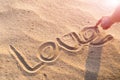 LOVE word writing on the white sand nature on the beach. summer trip Royalty Free Stock Photo