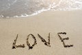 Love word written on the sand beach Royalty Free Stock Photo