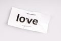 Love word written on torn and stapled paper Royalty Free Stock Photo