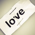 Love word written on torn and stapled paper Royalty Free Stock Photo