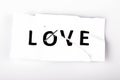 Love word written on torn and stapled paper on white Royalty Free Stock Photo