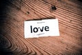 Love word written on torn and stapled paper Royalty Free Stock Photo