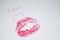 `Love` is written on the paper with heart, kiss