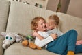 Love you brother. Cute little children, boy and girl cuddling on the sofa at home, showing love and care Royalty Free Stock Photo