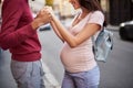 Happy future parents having tender moment on the street