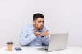 Love you! Handsome elegant businessman sitting office workplace, sending air kiss to laptop screen, talking on video call Royalty Free Stock Photo