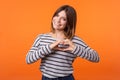 Love you. Portrait of attractive romantic young woman with brown hair in long sleeve striped shirt. indoor studio shot isolated on Royalty Free Stock Photo