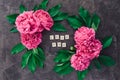 Love you text on wooden blocks border with the frame made of fresh pink peonies with green leaves on black stone background. Flat Royalty Free Stock Photo