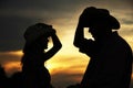 In love young couple on haystacks in cowboy hats Royalty Free Stock Photo