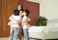 Love your kids. Happy latin children, teenage girl and two little twin boys hugging their mother while having fun