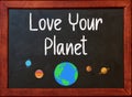 Love Your Planet. Motivational Quote on blackboard Royalty Free Stock Photo