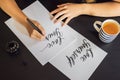 Love yourself. Calligrapher Young Woman writes phrase on white paper. Inscribing ornamental decorated letters