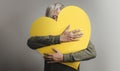 Love Yourself Concept. Happy Person Embracing Self, Hugging a Big Heart. Looking into Camera. Positive Mind Royalty Free Stock Photo