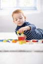 Lovely 3 year old playing with cubes at home