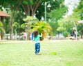 Lovely active little asian girl playing with soap bubble outdoor in the park Royalty Free Stock Photo