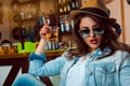 Lovely adult female in sunglasses with make up and healthy skin