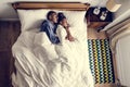 Lovely African American couple snuggling in bed