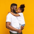 Lovely african american daddy and daughter touching noses and cuddling Royalty Free Stock Photo