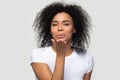 Lovely african young woman sending air kiss studio shot Royalty Free Stock Photo