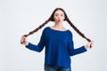 Lovely amusing woman with two long braids making funny face Royalty Free Stock Photo