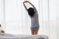 Asian woman stretch lazily in bedroom Royalty Free Stock Photo