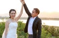 Lovely Asian bride and groom dancing against the sunset scene Royalty Free Stock Photo