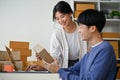A lovely Asian couple is rechecking and examining products before sending them to customers Royalty Free Stock Photo
