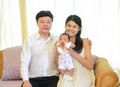 Lovely Asian family holding 1-month-old newborn baby boy on hand, Lovely,