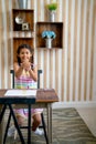 Lovely Asian girl sit on chair and show action of playing hands in classroom during relax and rest between time of the subject at