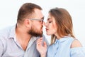 Lovely attractive couple sitting together on the white sand beach, looking each other, young couple kissing on the beach, love, ro Royalty Free Stock Photo