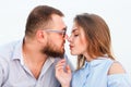 Lovely attractive couple sitting together on the white sand beach, looking each other, young couple kissing on the beach, love, ro Royalty Free Stock Photo