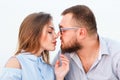 Lovely attractive couple sitting together on the white sand beach, looking each other, young couple kissing on the beach, love, ro Royalty Free Stock Photo