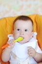 Lovely baby age of 9 months with spoon